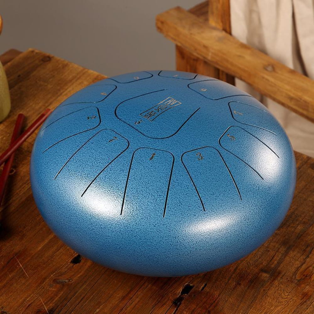 Metallic blue Carbon Steel tongue drum with 11 notes in C key and intricate carvings