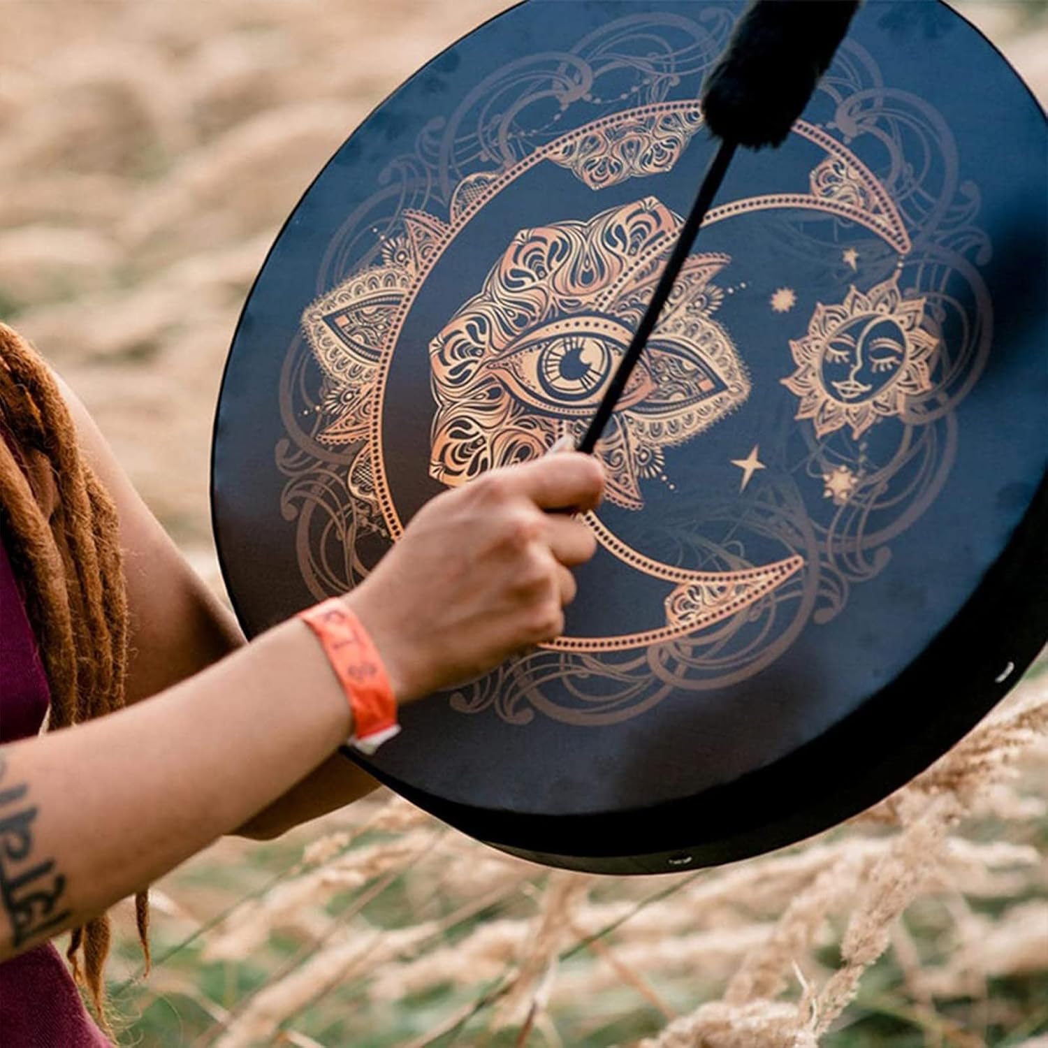 Circular drum with celestial moon and star designs in metallic patterns for sound healing