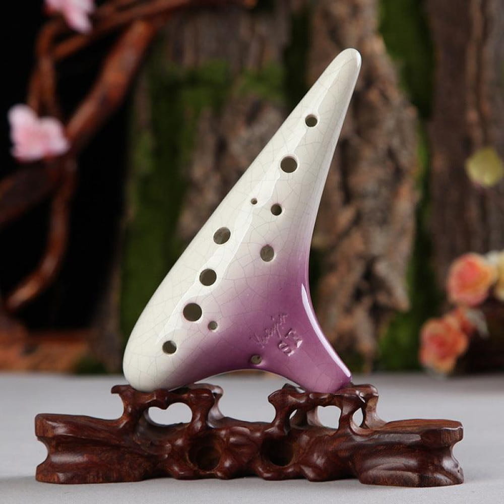 White and purple ceramic 12 Hole Soprano Treble Ocarina on wooden stand