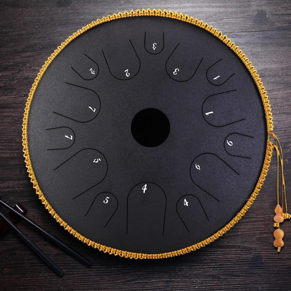 Black steel tongue drum with gold trim, part of the 14-Inch Alloy Copper Steel Tongue Drum