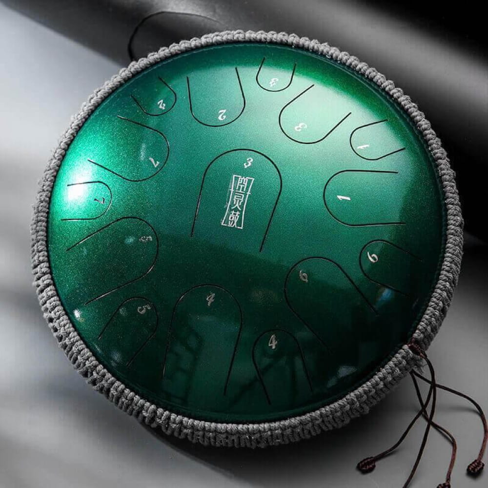 Metallic green tongue drum with woven gray border, 15 notes in C and D Major