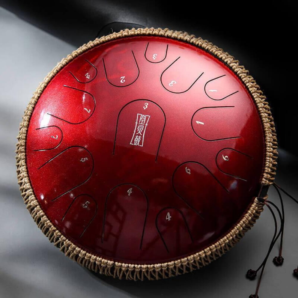 Red metallic tongue drum with woven rope edging for meditation and relaxation music