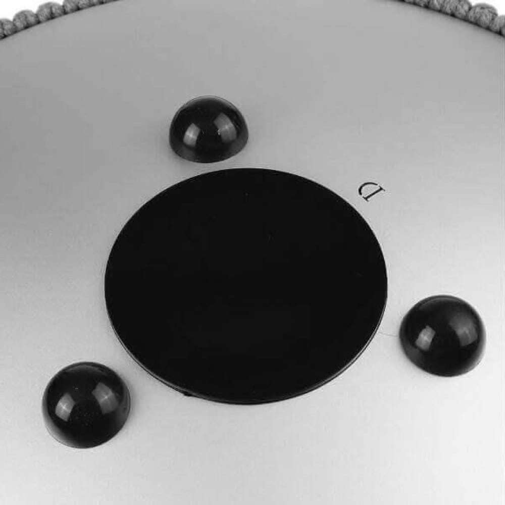 Black circular disc with three dark spheres, featuring a 14 Inch Titanium Steel Tongue Drum