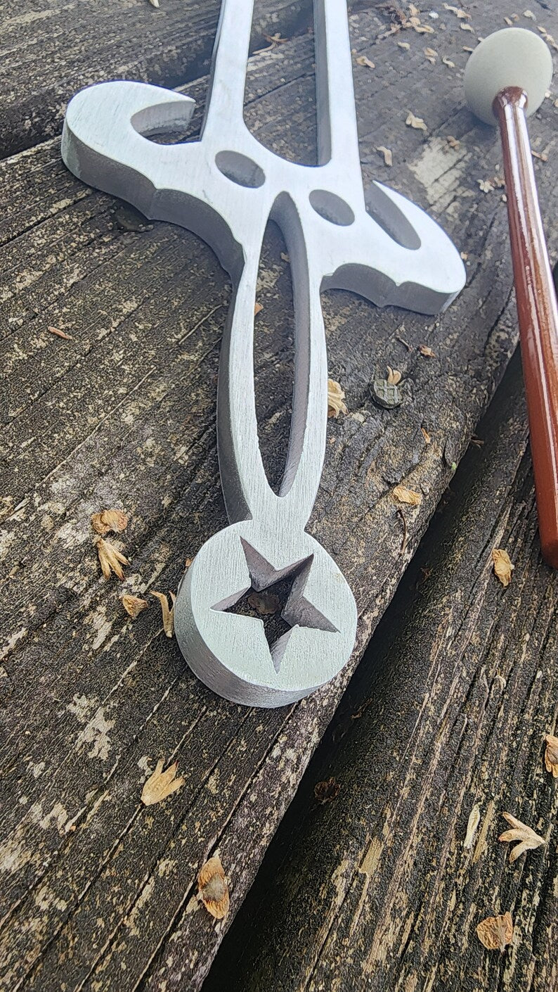 White metal sword with star design at blade base, part of Trident Large Tuning Fork