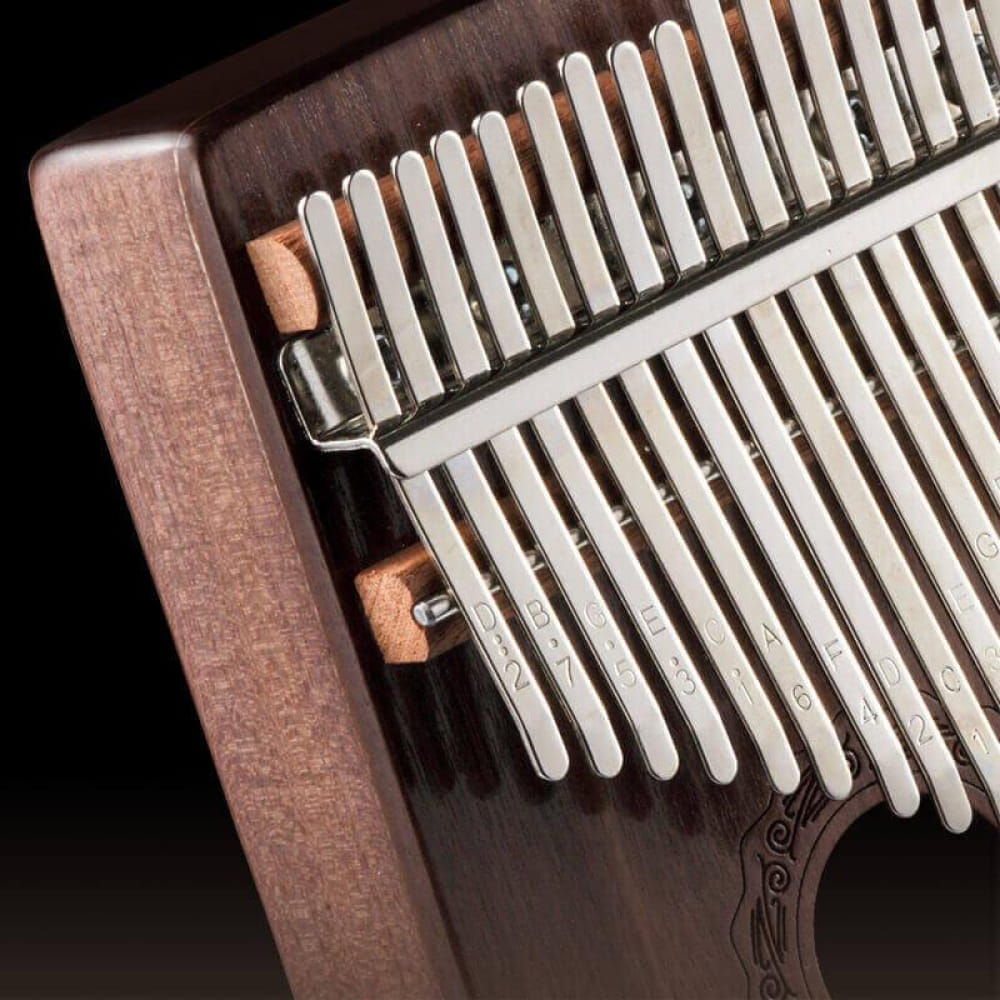 Kalimba musical instrument with metal tines on wooden base for C Tone music