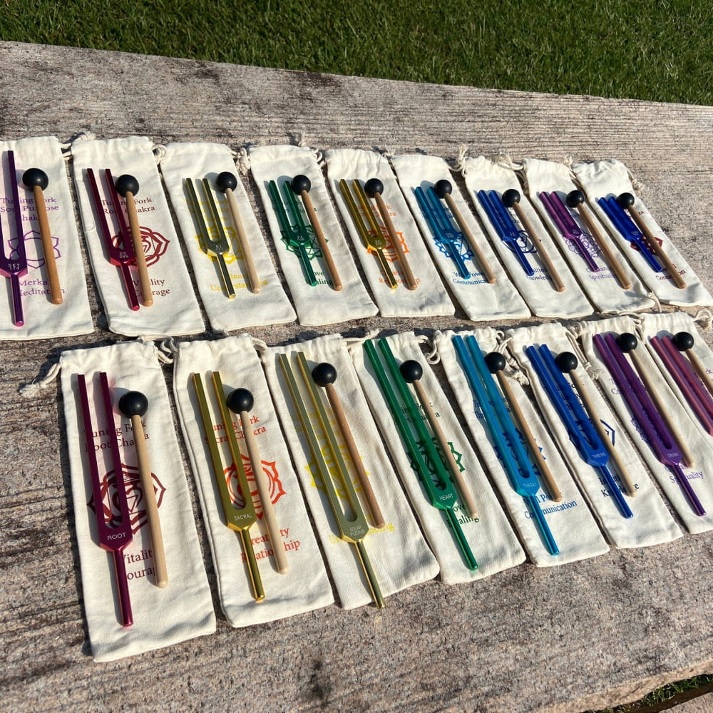 Colorful glass wine bottle stoppers in fabric sleeves from Solfeggio Chakra Set