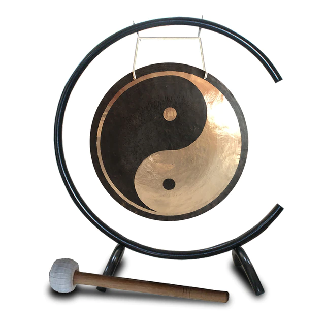 Yin-yang gong on curved metal stand with wooden mallet for sound healing