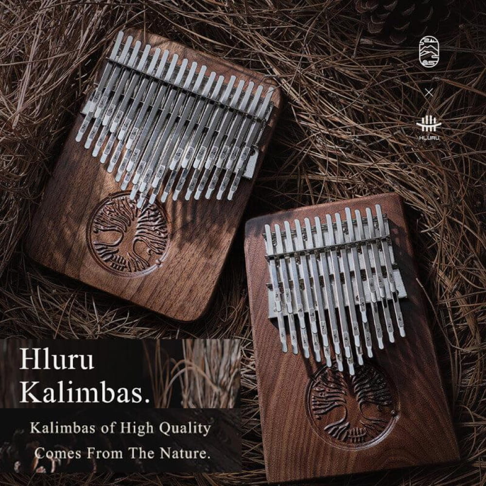 Two wooden kalimbas with metal tines and carved tree designs from 24 Key Double Layer Walnut Kalimba