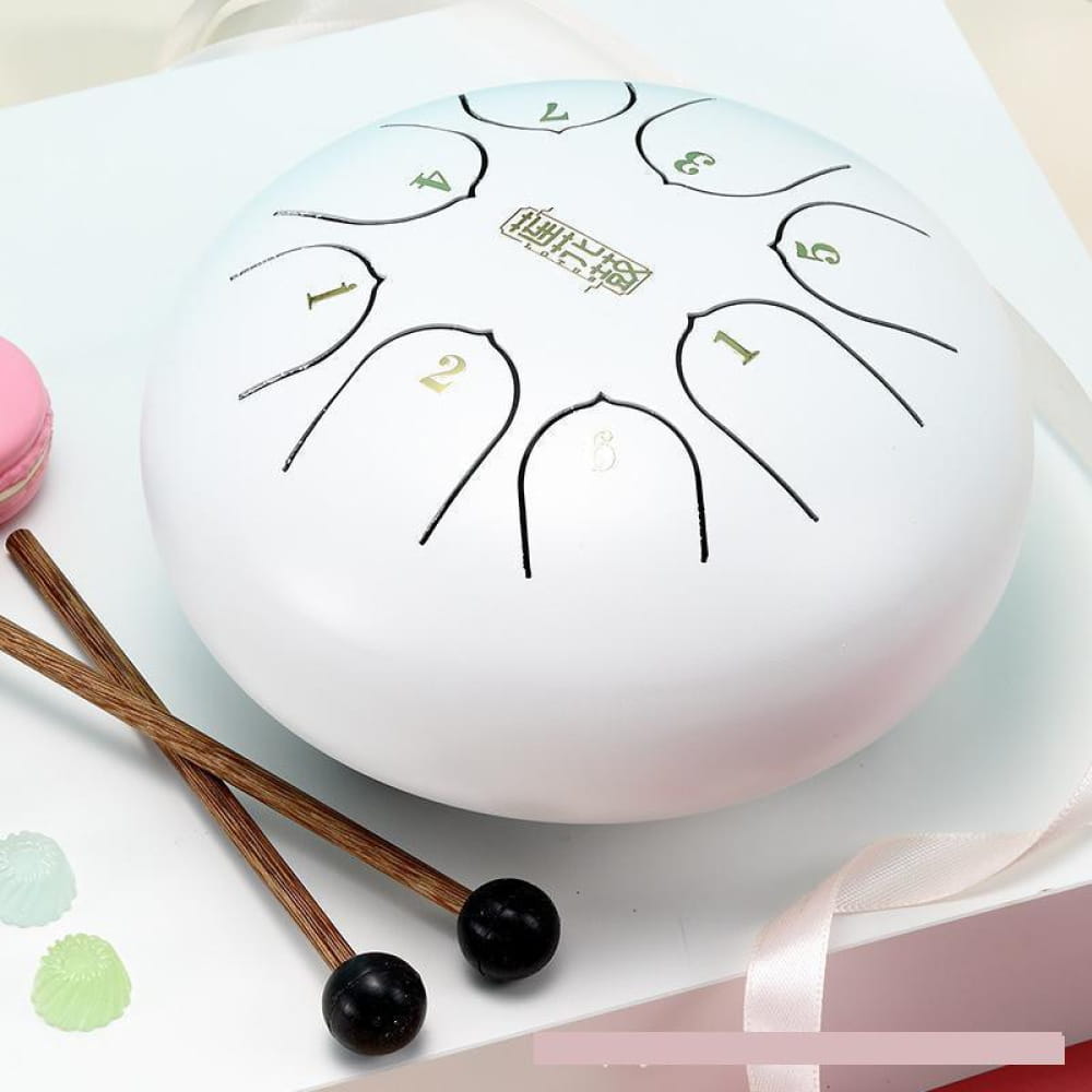 White steel tongue drum with numbered markings and mallets for beginners and kids