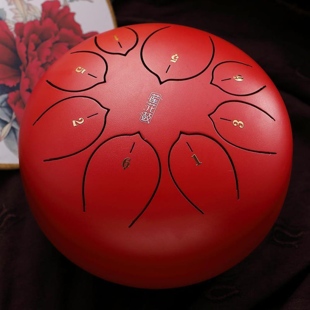 Red carbon steel tongue drum with numbered tone zones in black, F key, 8 tones