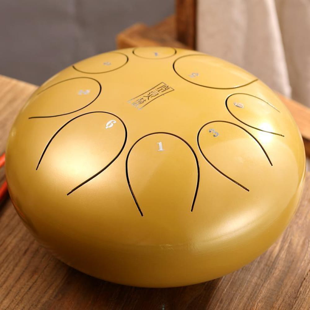 Golden tongue drum with curved tone markings, 8-Tone D Key Steel Tongue Drum, 10 Inch