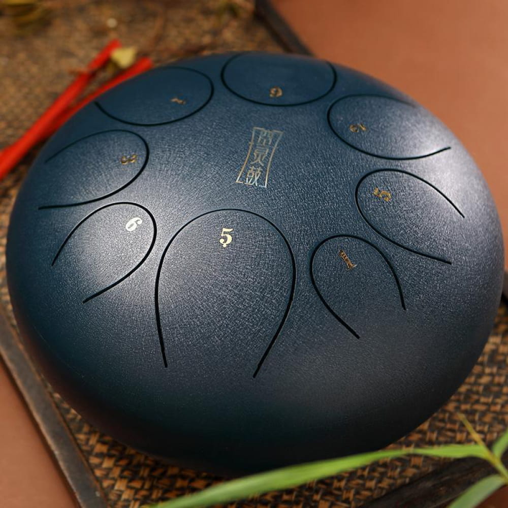 Steel tongue drum with numbered tone zones in dark blue, 10-inch round instrument
