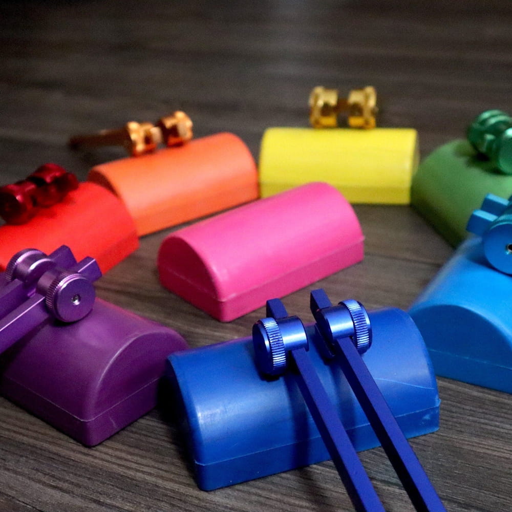Colorful plastic handbells in a rainbow pattern for Crystal & Onyx Massage Handles