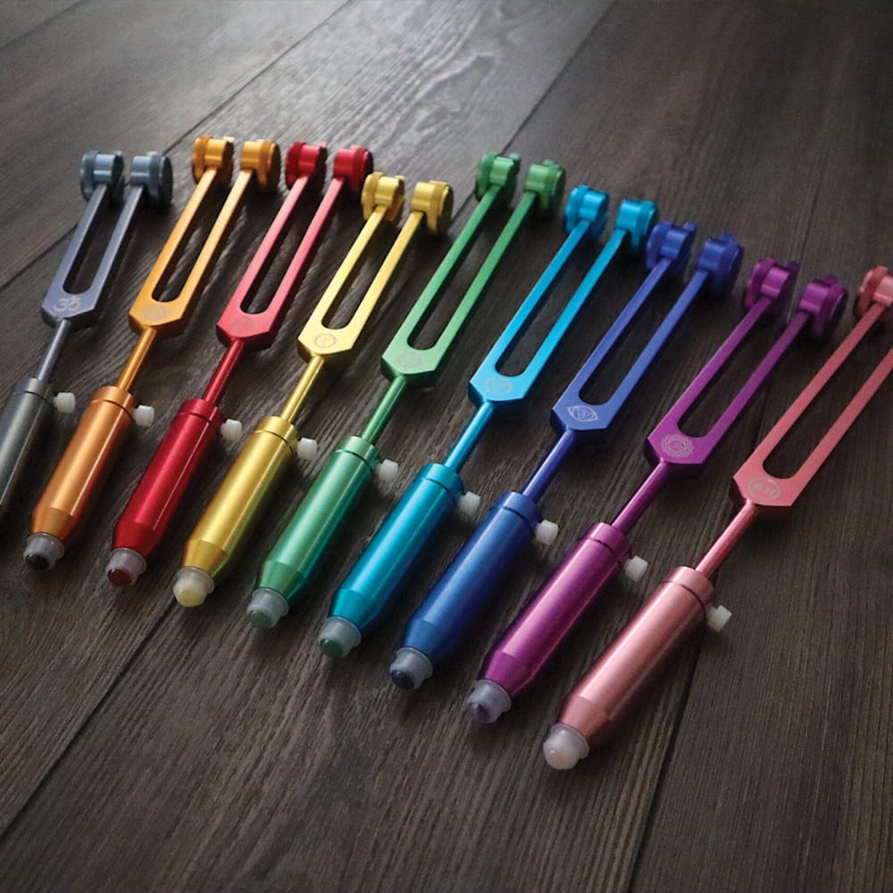Rainbow-colored tuning forks in a spectrum for Gemstone Aromatherapy Tuning Forks Extensions