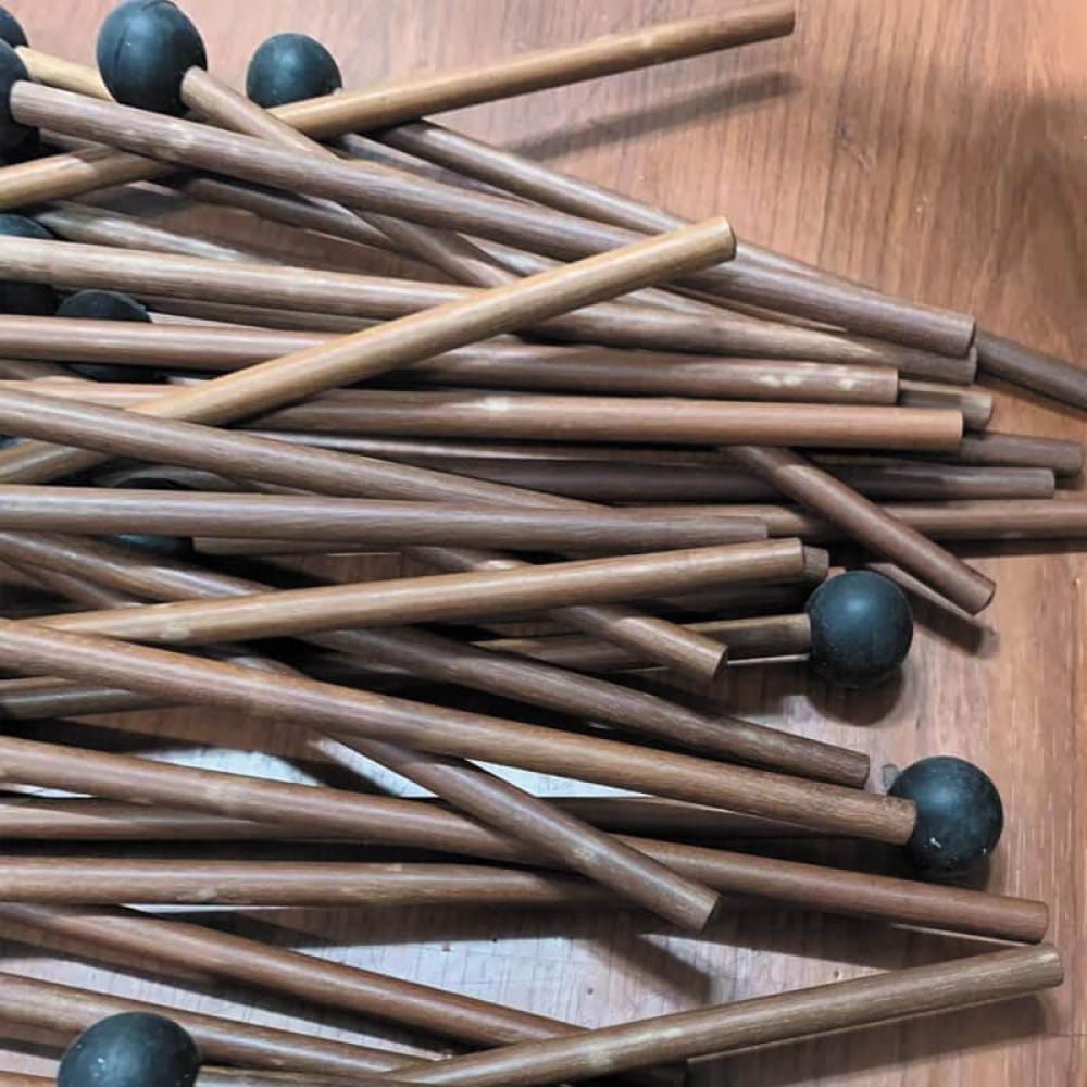 Premium Wooden Drumsticks surrounded by dark blue spheres and wooden rods