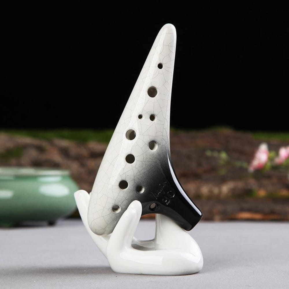 White ceramic 12 Hole Soprano Ocarina with black accents and finger holes