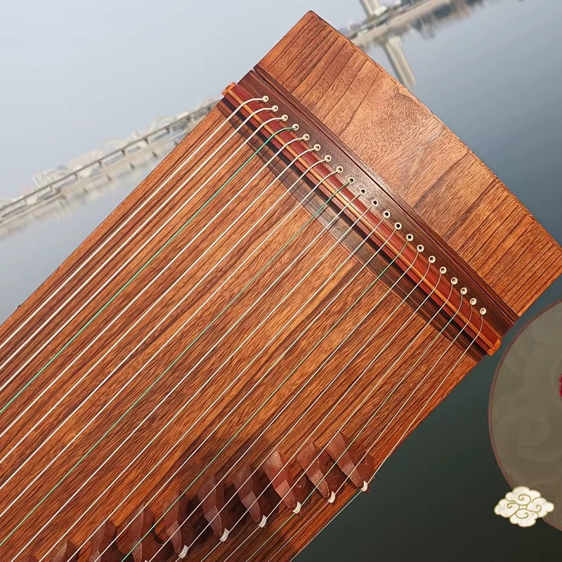 Traditional Chinese Guzheng strings and bridge detail in warm wooden tones
