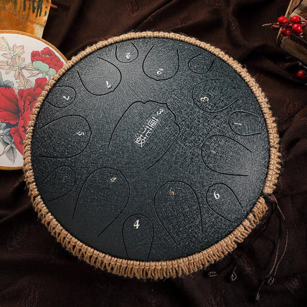 13-Inch Carbon Steel Tongue Drum featuring numbered zones and woven rope trim