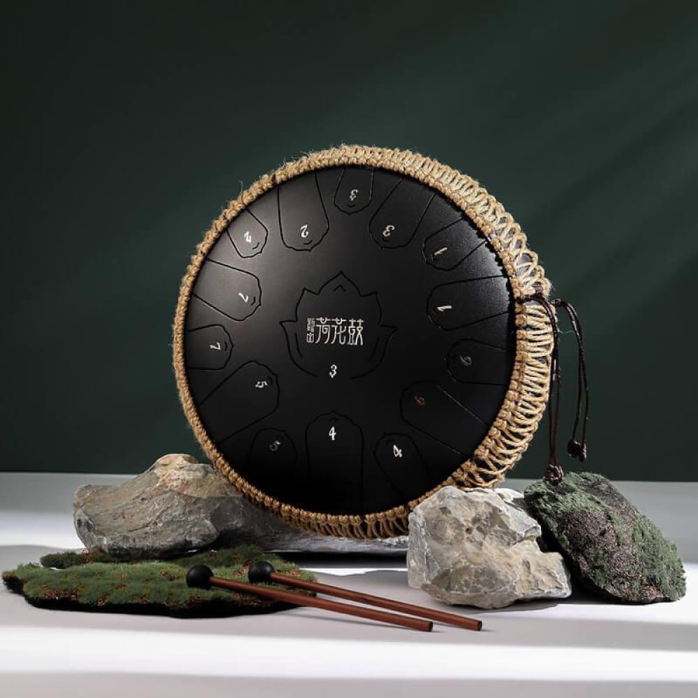 Black steel tongue drum with woven rope border and 15 tone zones in C Major