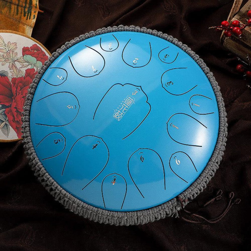 Bright blue 14-Inch Carbon Steel Tongue Drum with decorative gray fringe and 15 notes