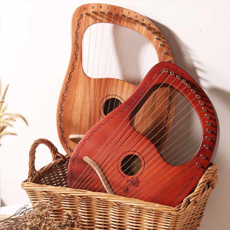 Two wooden lyres with strings in a wicker basket for the 16-String Lyre Harp Instrument