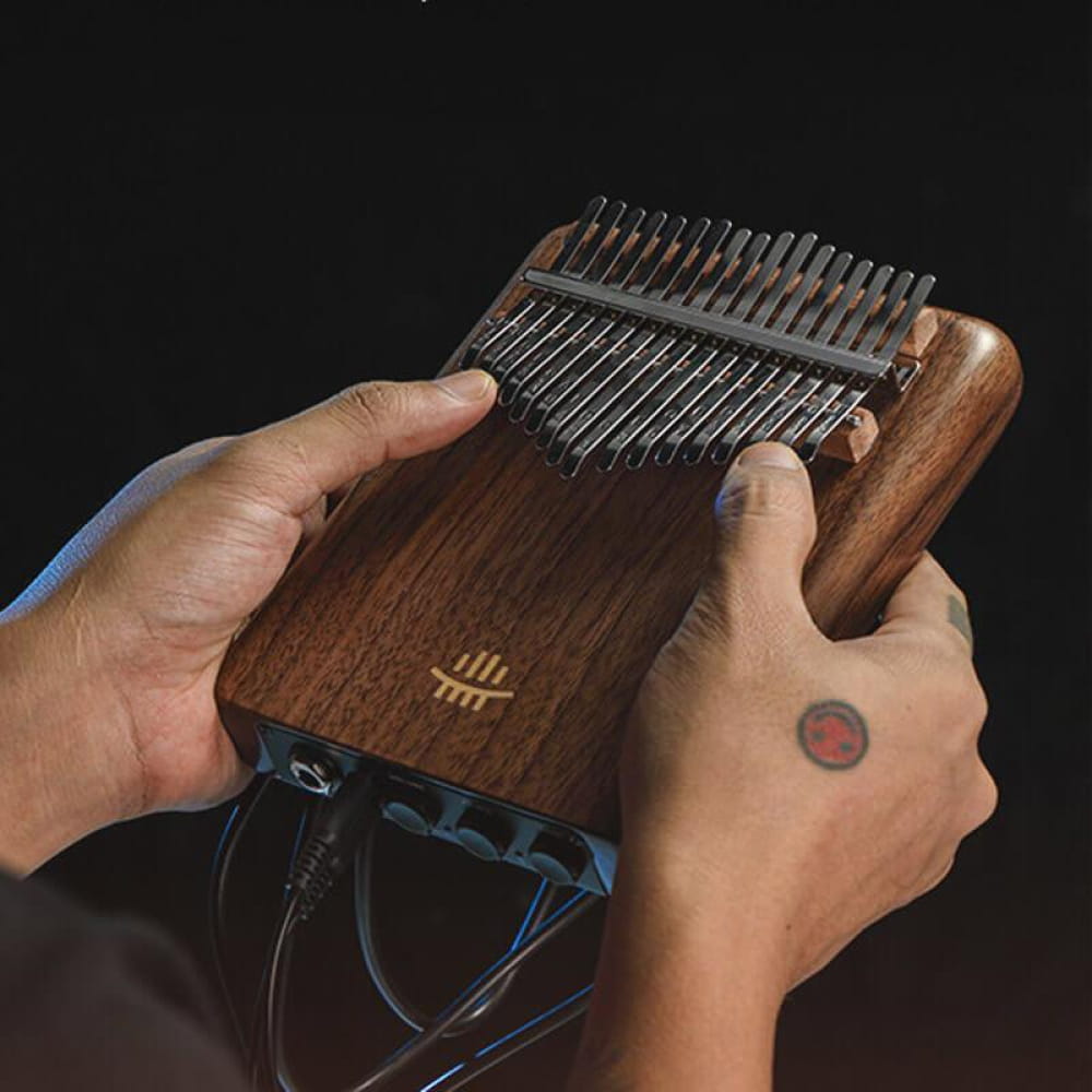 Wooden Kalimba thumb piano with metal tines played by hands, 17/21 Key Flat Board C Tone