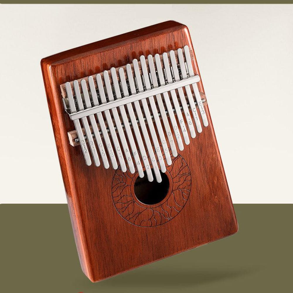 Wooden Kalimba thumb piano with metal tines and circular engraving in Acacia design