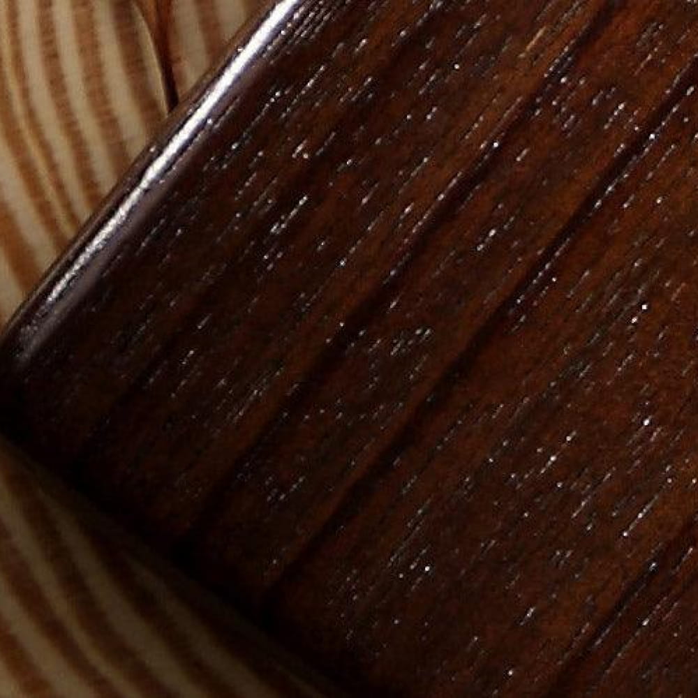Dark stained rosewood surface highlighting grain texture of 17 Key Thumb Piano