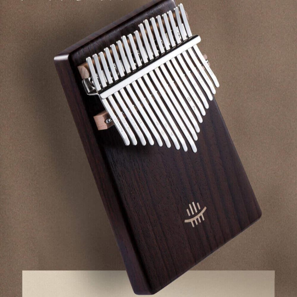 Dark wooden Kalimba with white metal tines for meditation and musical relaxation