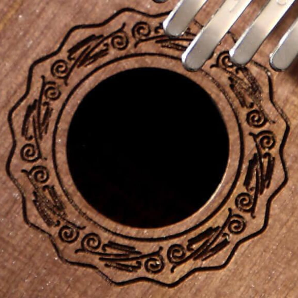Decorative rosette pattern around circular sound hole on 17 Key Walnut Kalimba Thumb Piano