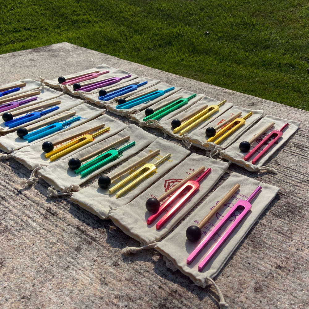 Colorful markers on white fabric rolls in 17-Piece Solfeggio Chakra Tuning Fork Set