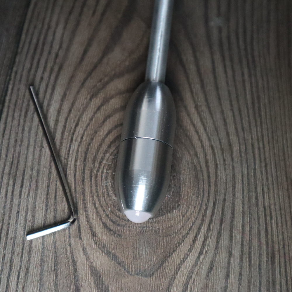 Silver metallic bullet-shaped tuning fork with crystal handle for sound healing