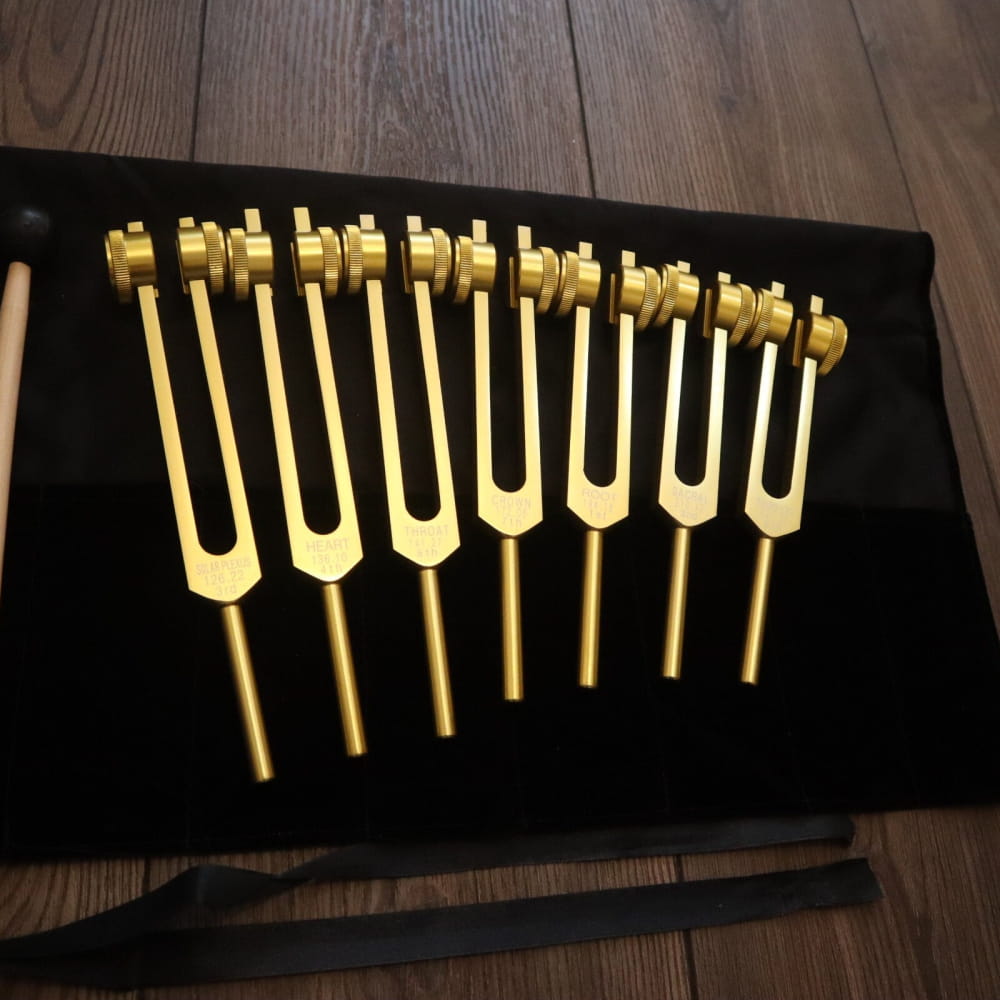Set of golden tuning forks in a row, part of 17pc Solfeggio & Chakra Tuning Fork Set