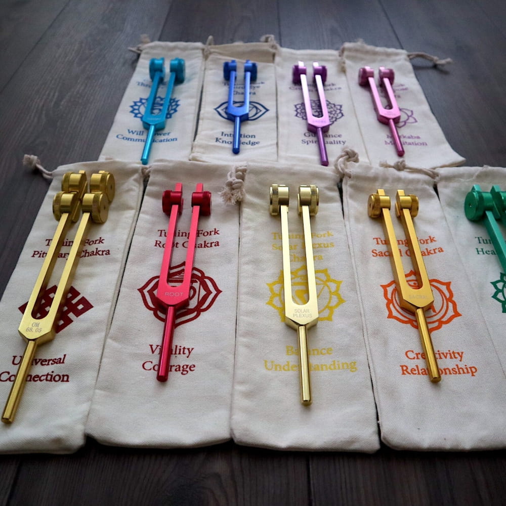Colorful tuning forks and matching fabric pouches in a Solfeggio Chakra set