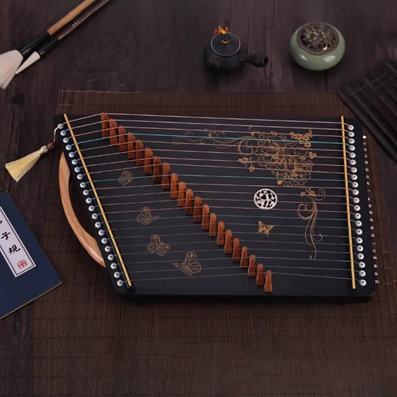 Traditional Chinese Guzheng with butterfly and floral designs on black surface