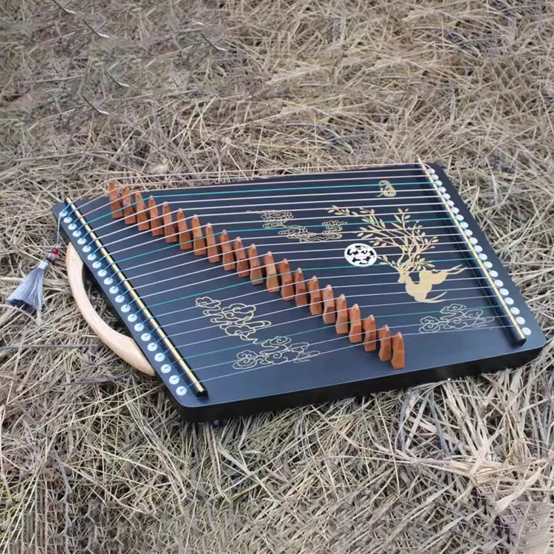 Traditional Chinese Guzheng with decorative deer and floral designs on black surface