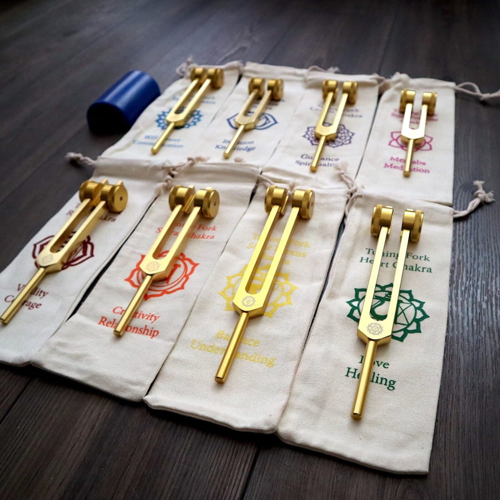 Golden tuning forks on decorative cloth pouches for 24K Gold Chakra Tuning Fork Set
