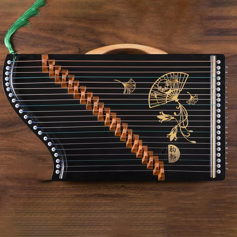 Black stringed zither with gold fan designs and wooden bridges in Mini Guzheng 21-String