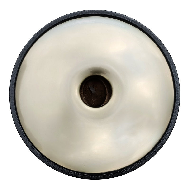 White glazed donut with black rim on 432 Hz G Minor Handpan Drum for relaxation