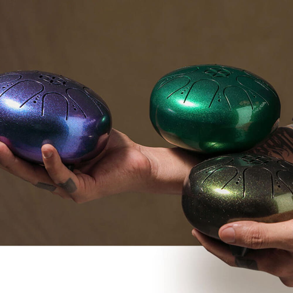 Three metallic tongue drums in purple, green, and gold in C Key Mini Steel design