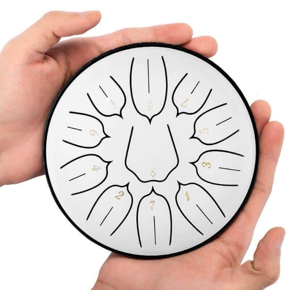 Circular steel tongue drum with lotus design tone markings in radial pattern