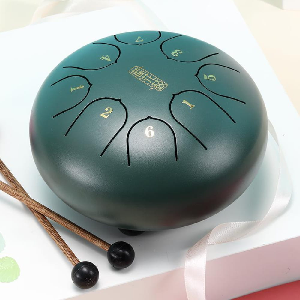 Teal steel tongue drum with numbered panels and mallets, ideal for kids’ music play