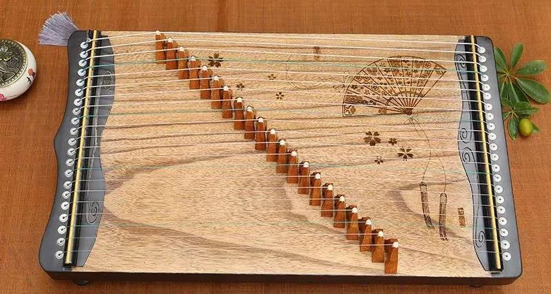 Wooden 60 cm Mini Guzheng with decorative etchings and 21 strings for music enthusiasts