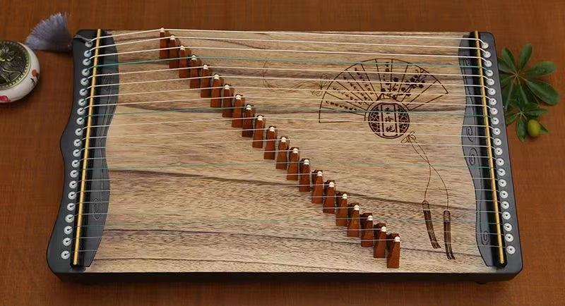 Wooden 21-string Guzheng with decorative fan design and diagonal string rows