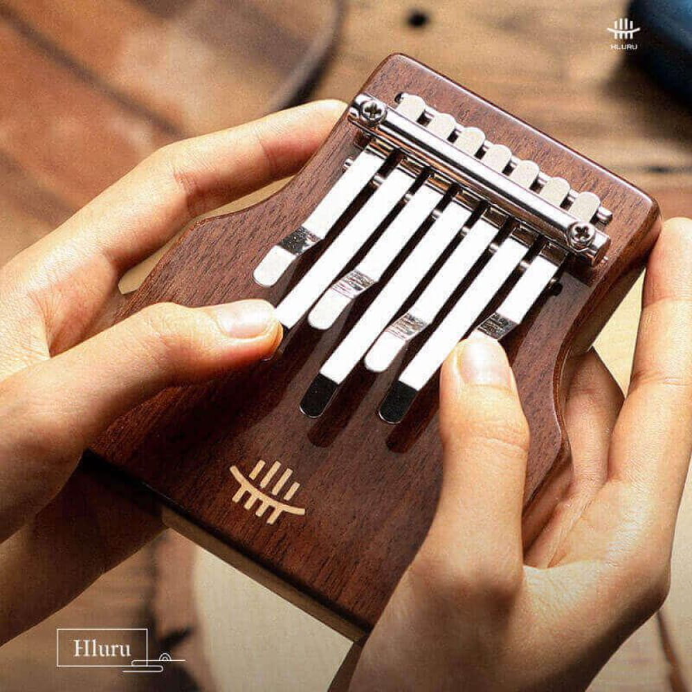 Wooden 7-Key C Tone Thumb Piano with metal tines and resonance hole, portable design