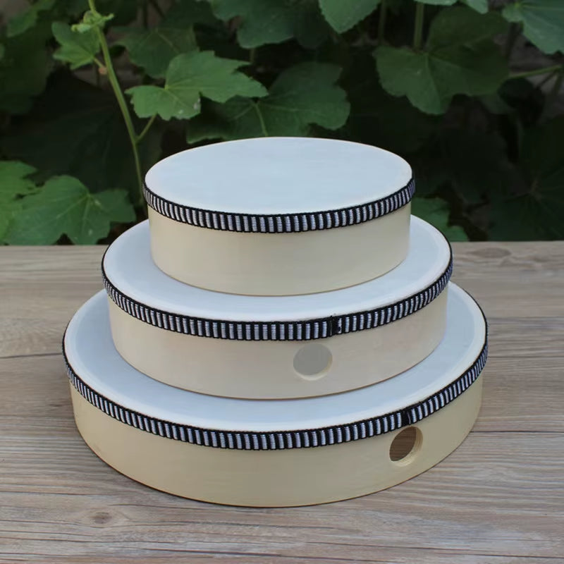 Cream-colored three-tiered cake stand with black and white striped trim for kids’ decor