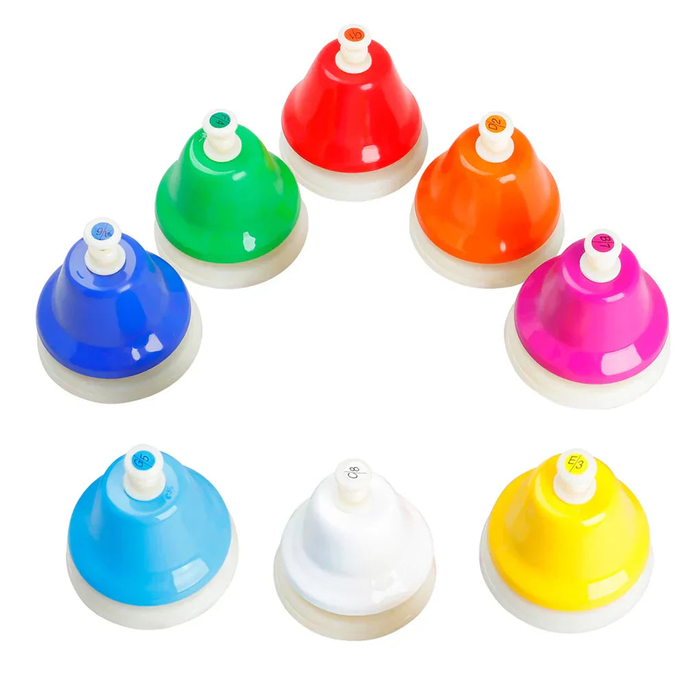 Colorful desk bells in a curve from the 8-Note Chakra Meditation Hand Bell Set