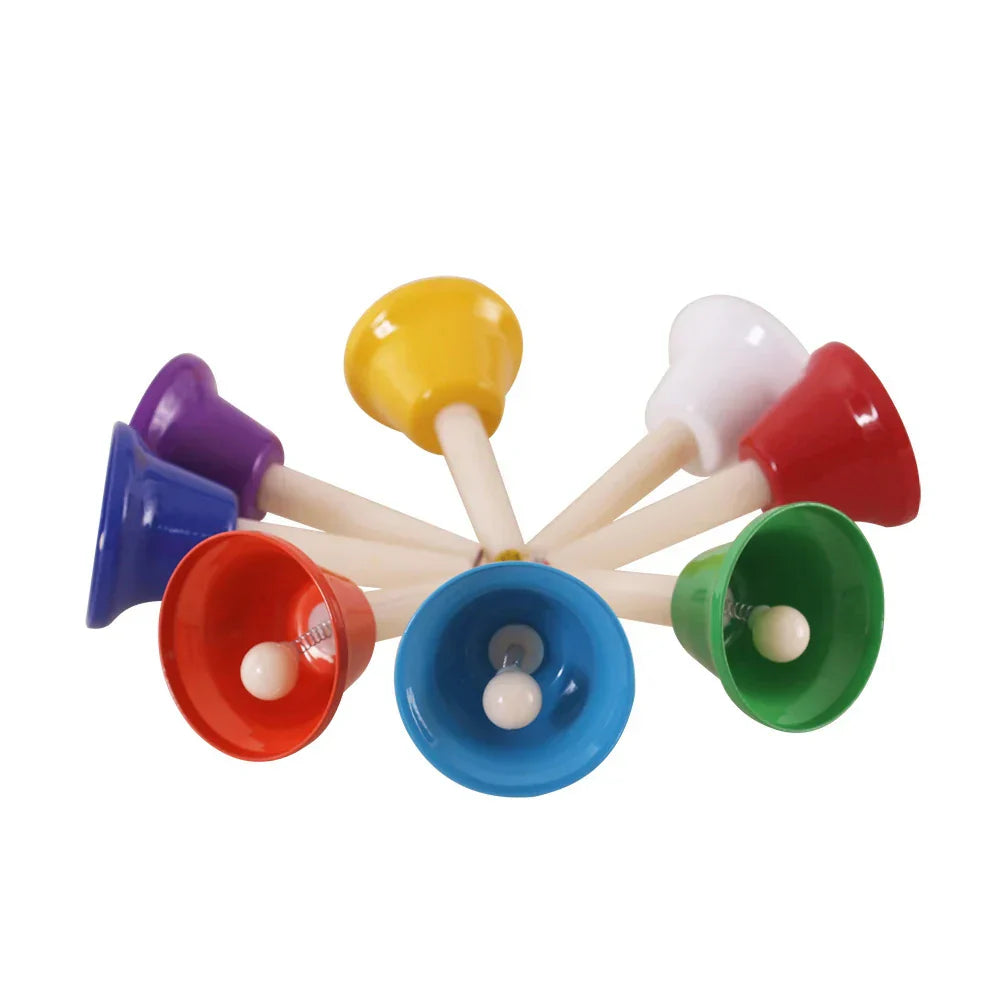 Colorful 8-Note Chakra Meditation Hand Bell Set with wooden handles in a circular arrangement