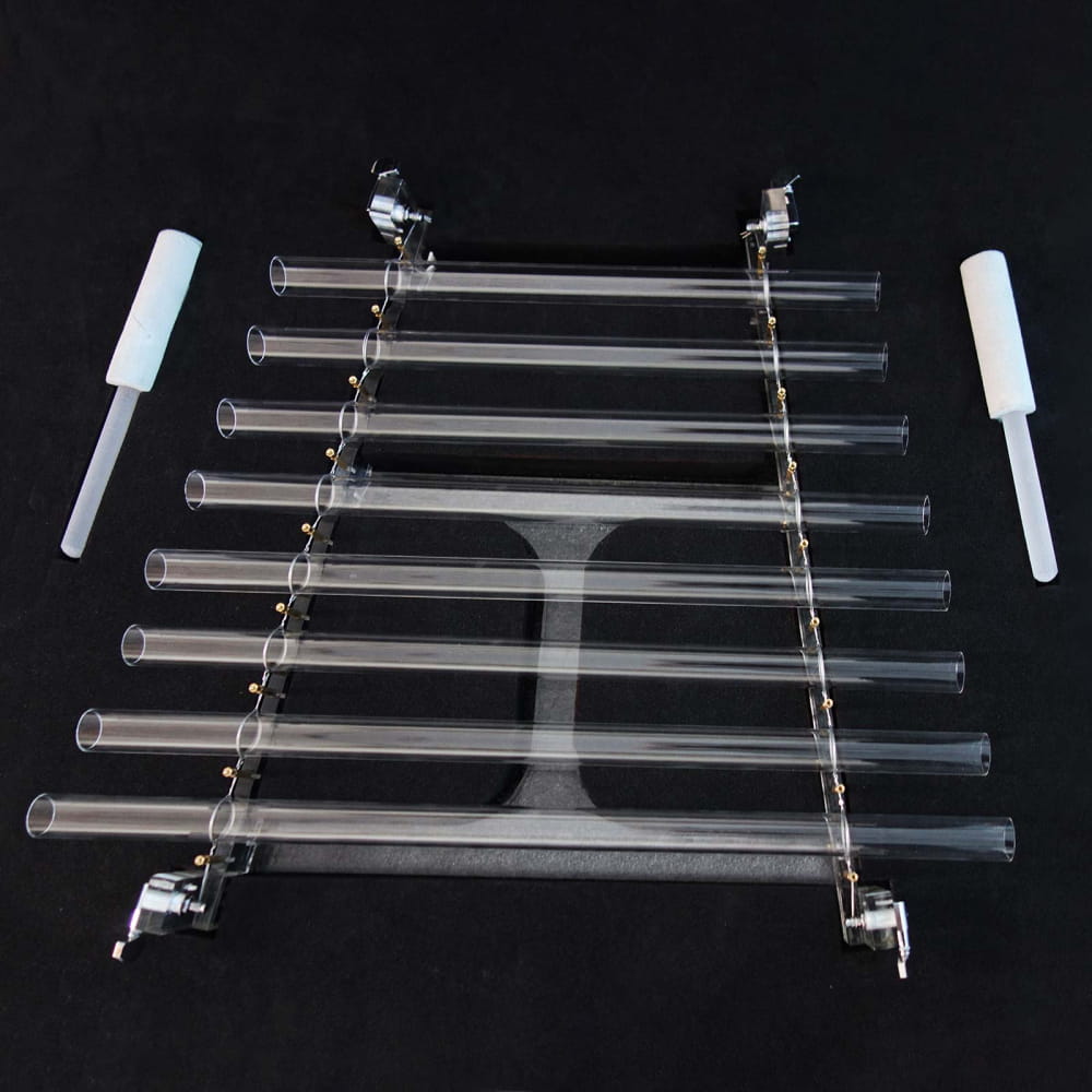 Glass test tubes in a metal rack with white stoppers beside the 8-Note Quartz Crystal Singing Harp