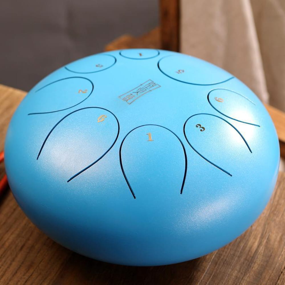 Light blue 8-inch steel tongue drum with curved tone markings and 8 notes in C5 key